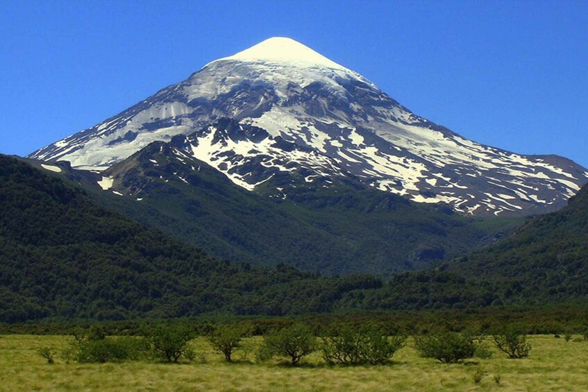 A snow-capped mountain with a clear sky. 2