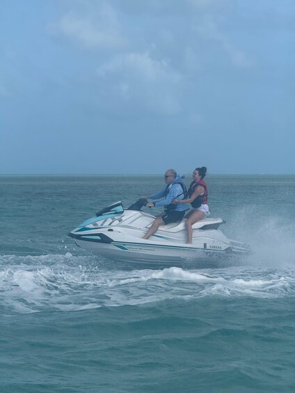 Two people on a jet ski in the ocean. 2