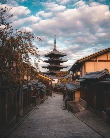 A traditional Japanese street with a pagoda in the distance. 1