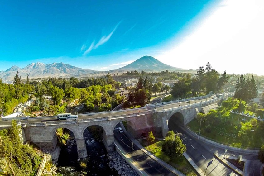 A bridge over a river with a mountain in the background. 5