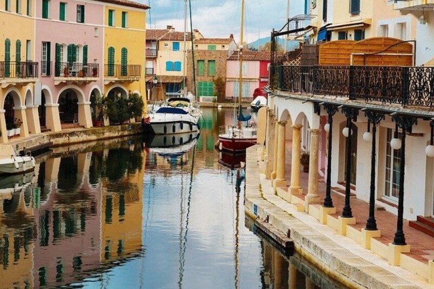 A canal with boats, colorful buildings, and a bridge. 2