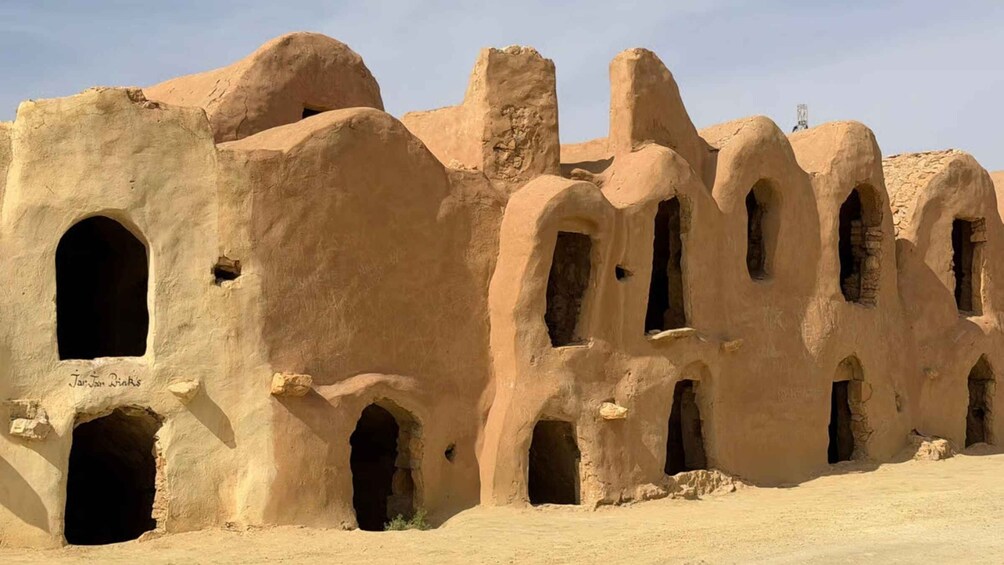 Ancient mud-brick structures with multiple arched openings. 4