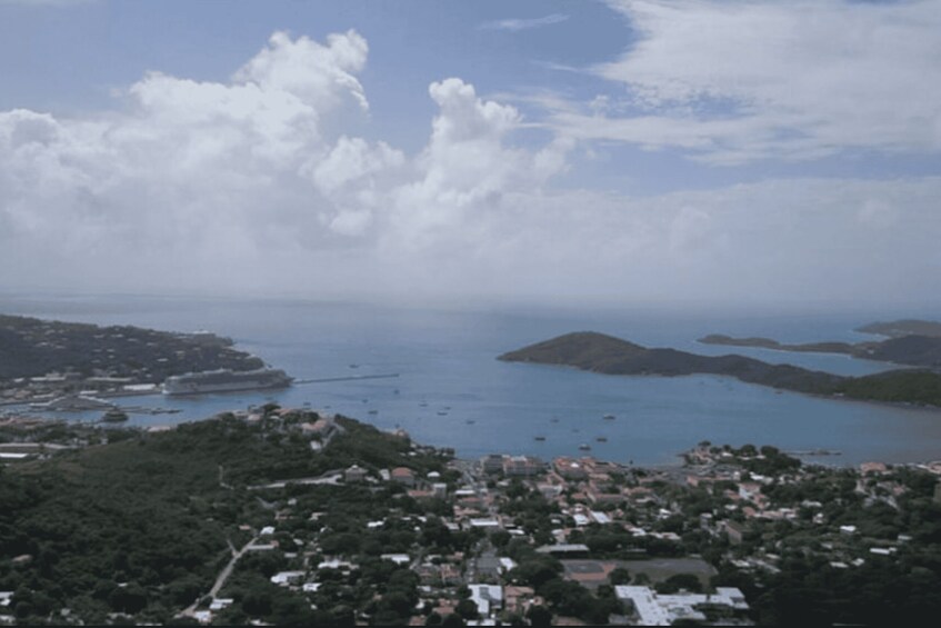 A coastal town with a marina, boats, and a hilly landscape. 4