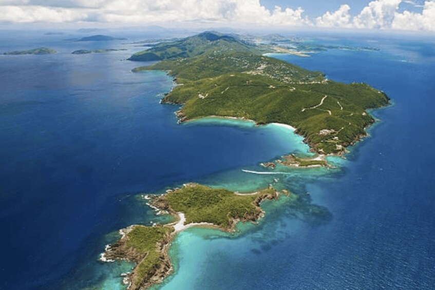 A chain of islands with clear blue waters and lush green vegetation. 3