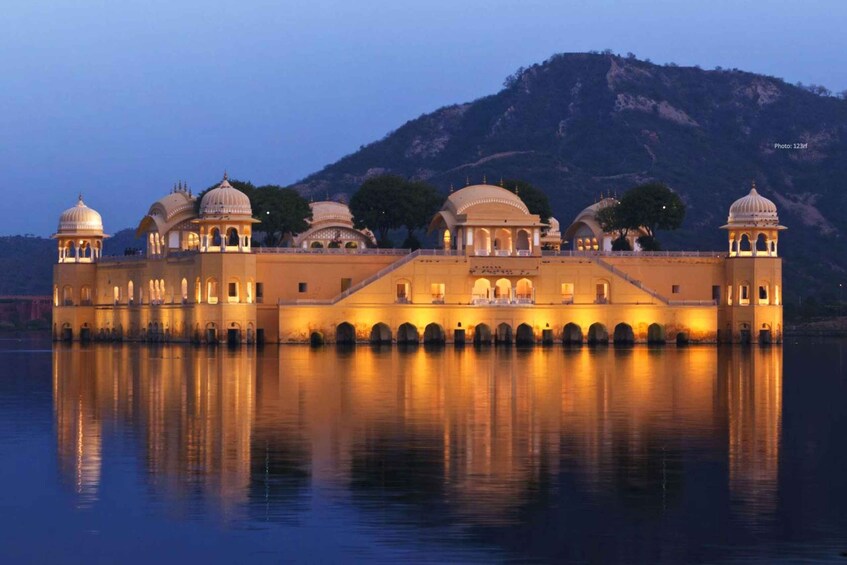 A palace with multiple domed structures and arched walkways reflecting on the water. 1