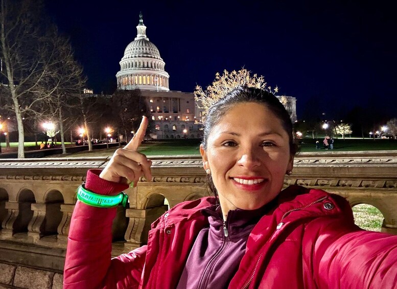A person taking a selfie with the Capitol building in the background. 1
