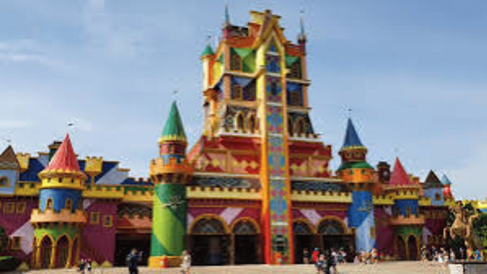 A colorful castle-like structure with multiple towers and a central spire. 3