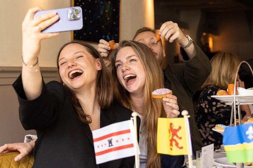 People taking a selfie, holding flags, and eating food. 5