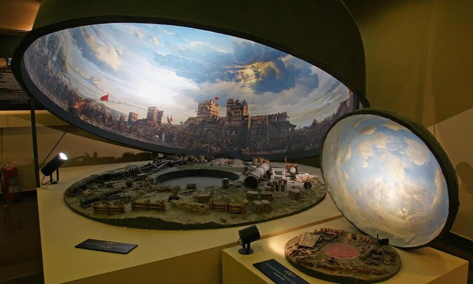 A museum exhibit with a large globe and a detailed diorama of a historical battle scene. 2