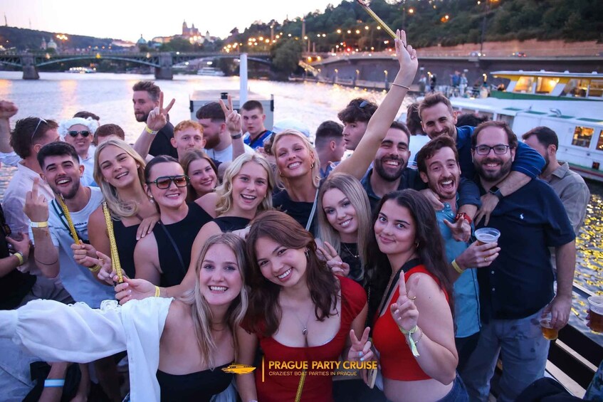 A group of people on a boat with a river and bridges in the background. 1