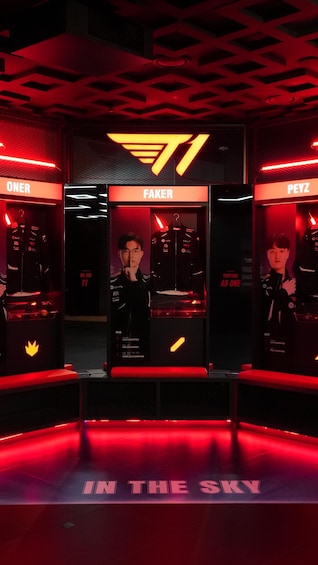 A gaming booth with three sections labeled 'ONEER', 'FAKER', and 'PEYZ'. Each section has a mannequin dressed in gaming attire. The booth is illuminated with red lighting and has a sign that reads 'IN THE SKY'. 4