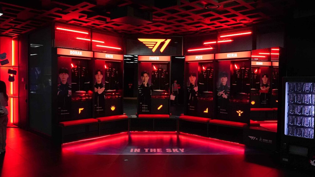 A gaming booth with multiple screens displaying players and the logo 'IN THE SKY'. 3