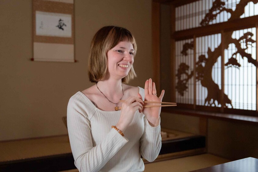 A person holding chopsticks. 1