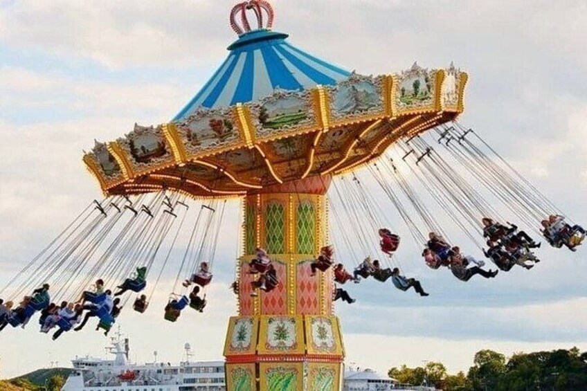 A colorful carousel with riders in motion. 4