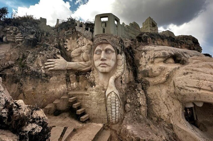 A large rock carving with a face and a lion's head. 3