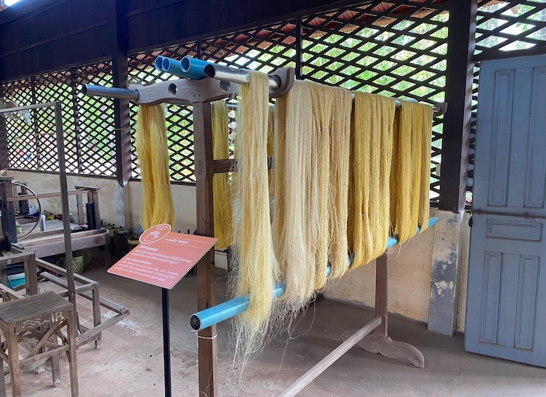 A textile workshop with yarn being spun on a wheel. 1