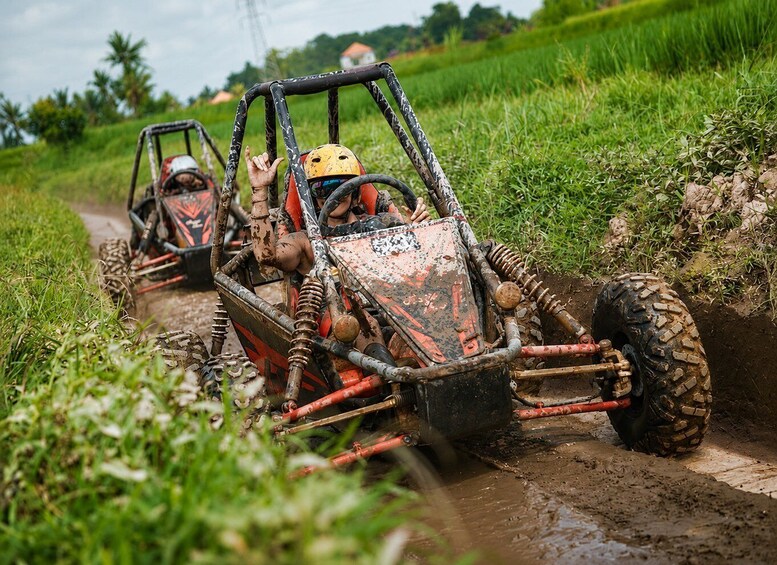 Two off-road vehicles on a muddy path in a rural area. 5