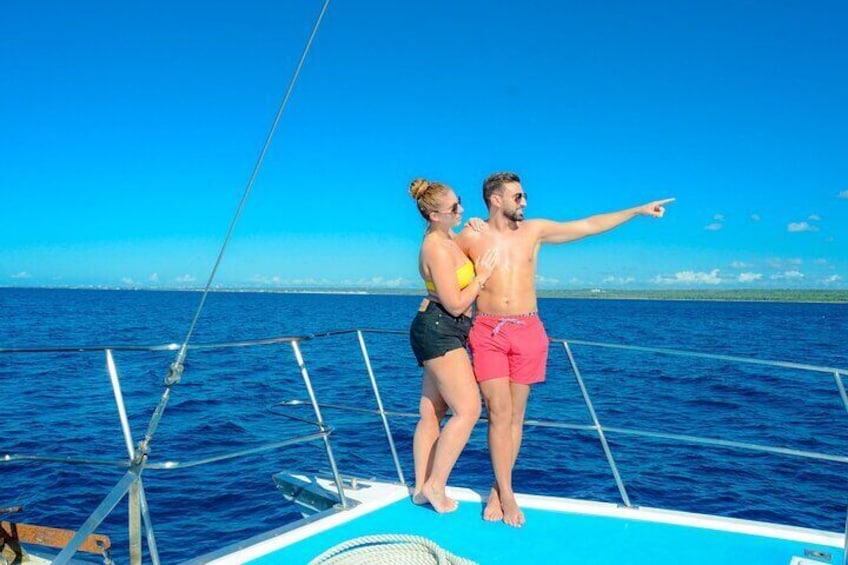 Two people on a boat with a clear blue sky and calm sea. 2