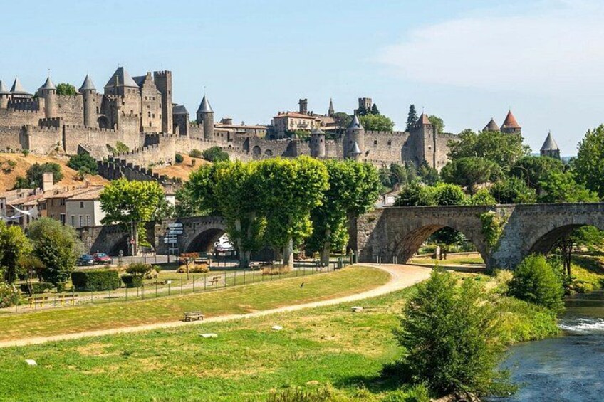 A historic castle, a stone bridge, and a river. 3