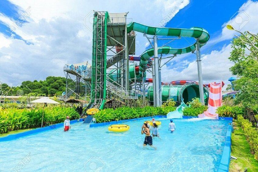 A water park with a large pool, water slides, and a tall water slide structure. 4