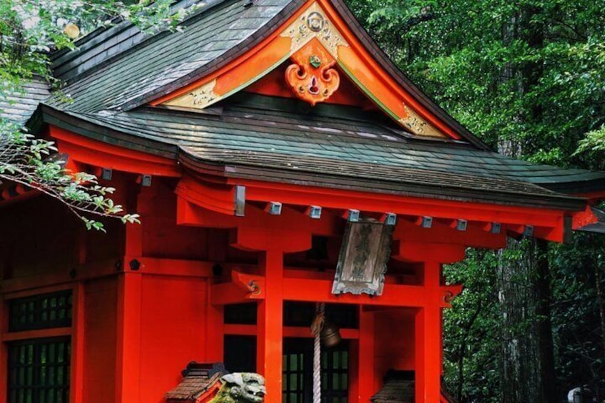 A traditional Japanese building with a red facade and a curved roof. 5
