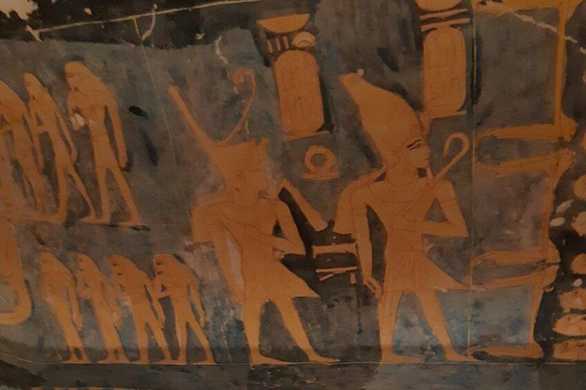 A faded ancient fresco with figures in profile view, some holding objects. 3