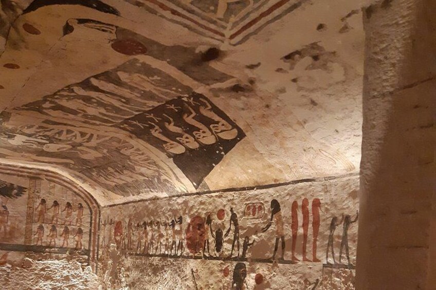 An ancient Egyptian tomb with hieroglyphs and a sarcophagus. 4