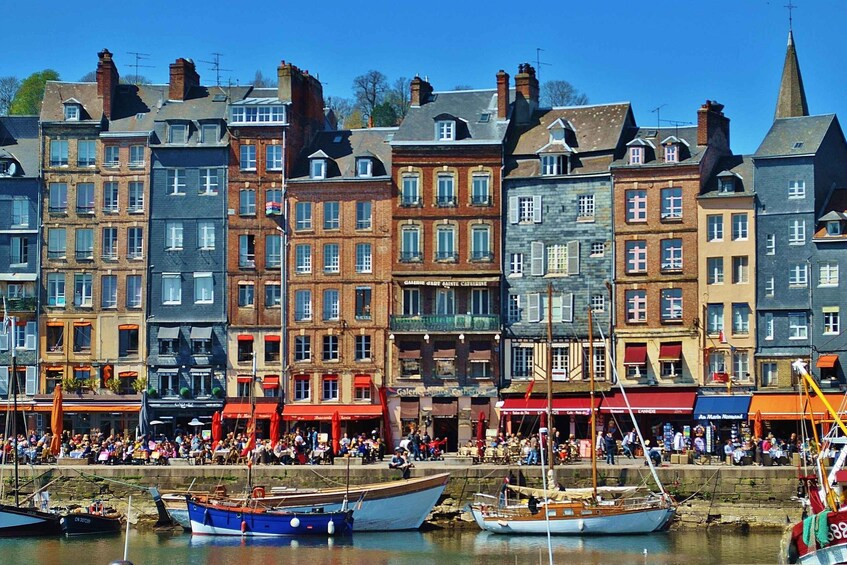 A waterfront with historic buildings and boats. 2