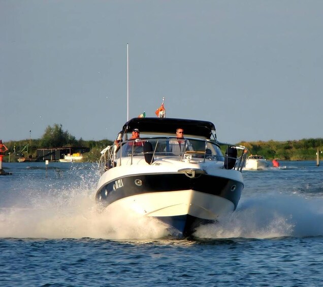 A boat speeding through water, creating a wake. 1