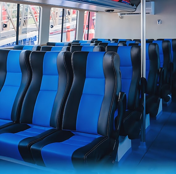 Rows of blue and black seats in a train carriage. 5