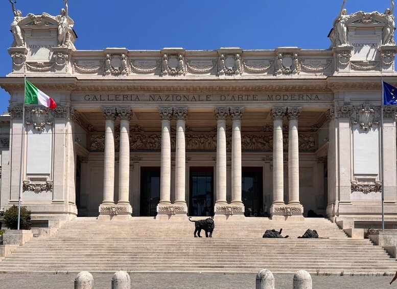 The entrance to the Galleria Nazionale D'Arte Moderna, featuring classical architecture with columns and statues. 1