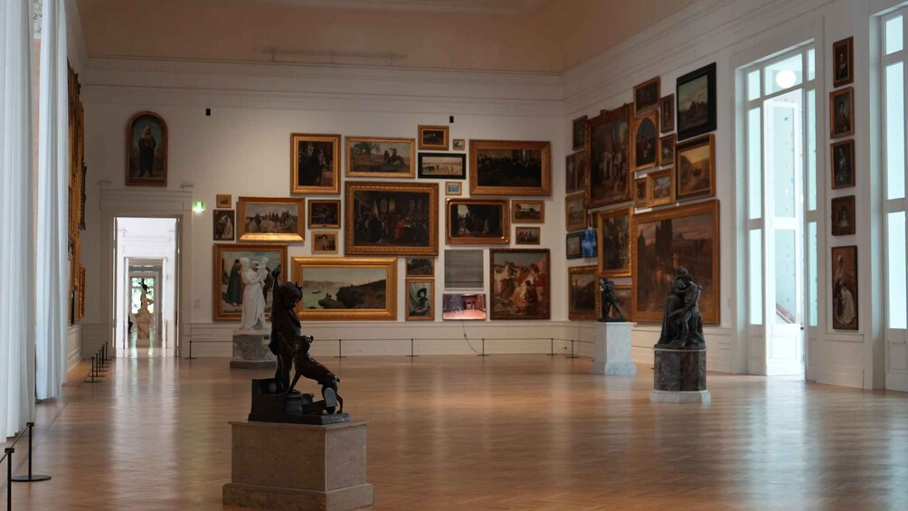 An art gallery with paintings and sculptures on display. 2