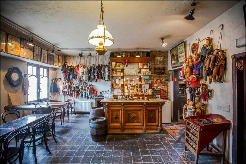 A vintage-themed bar with wooden furniture, a central bar counter, and various decorations including figurines and posters. 5
