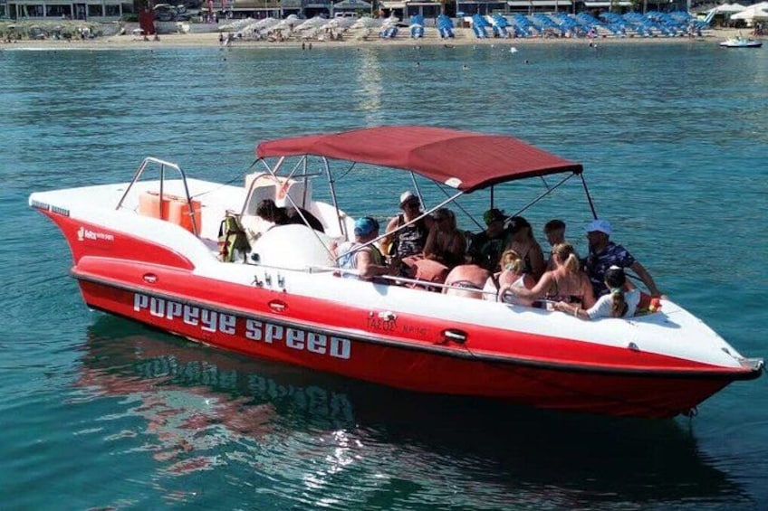 A red and white speedboat with passengers on a calm body of water. 5