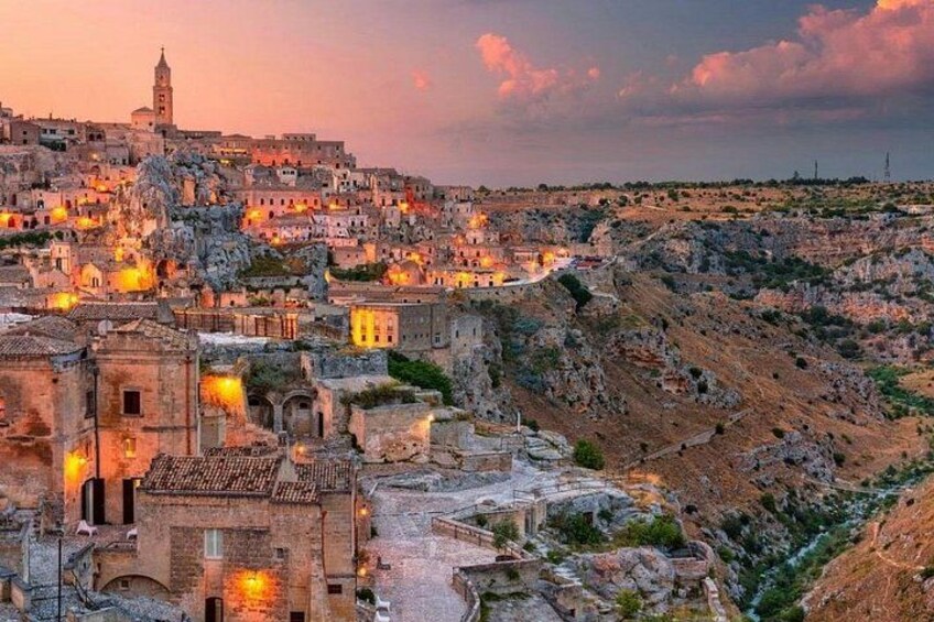 A historic town with ancient buildings, a prominent church, and a hilltop fortress. 3