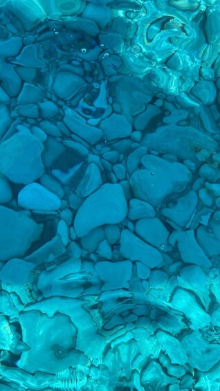 A close-up of a blue-tinted surface with various shapes and textures. 5
