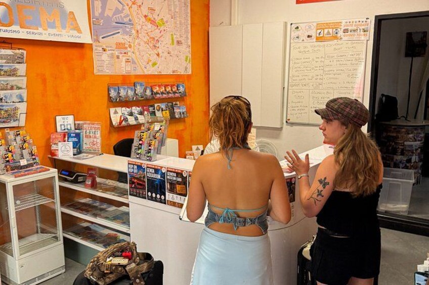 A travel agency with a map on the wall, brochures, and a counter. 2