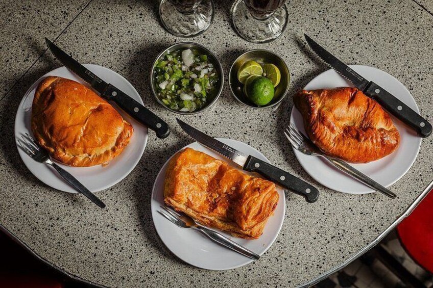 Three plates of roasted chicken on a speckled countertop. 5