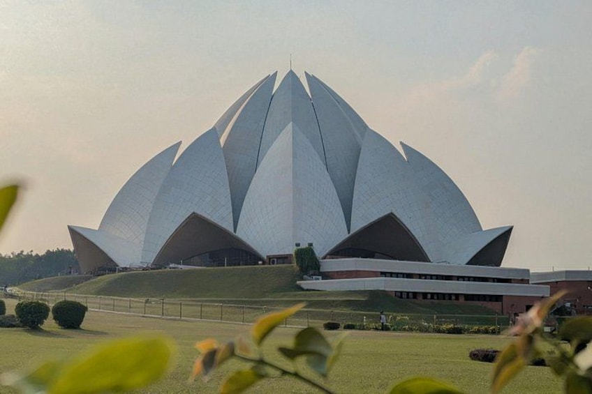 A large, white lotus-shaped building with multiple tiers. 1