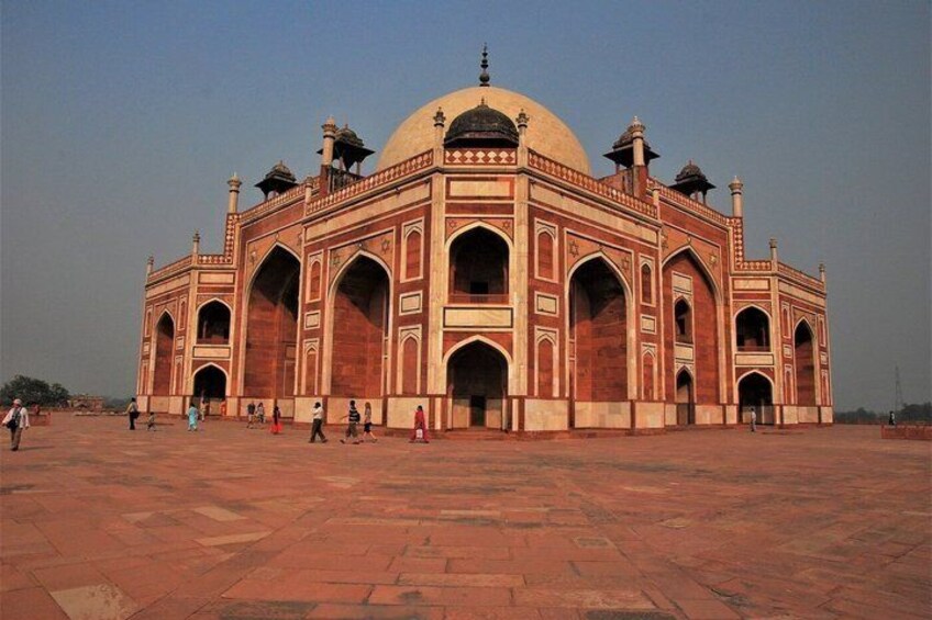 A large, historic building with a large central dome and four smaller domes, surrounded by a spacious courtyard. 4