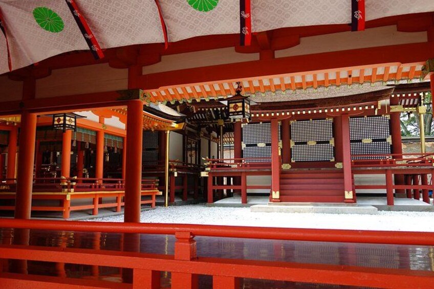 A traditional Japanese structure with red pillars and a tiled roof. 3