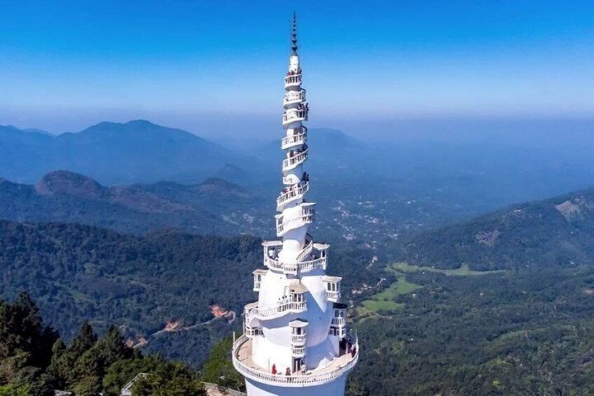 A white pagoda with multiple tiers, surrounded by a mountainous landscape. 5