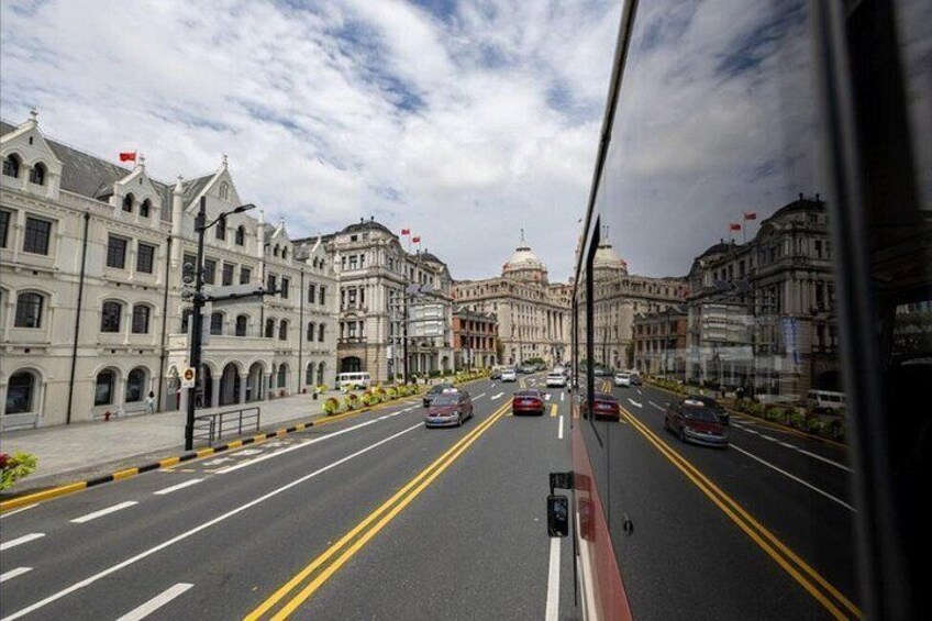 A multi-lane road with vehicles, buildings, and a clear sky. 3