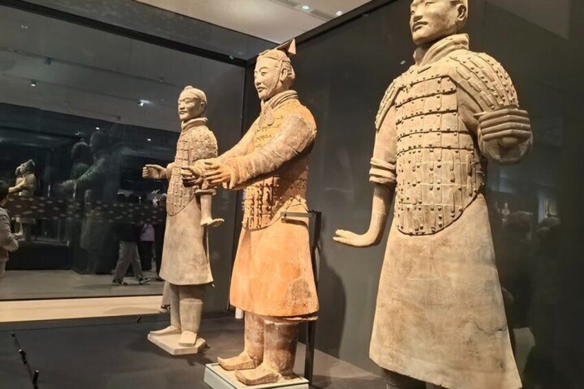 A museum display of three ancient terracotta warrior statues. 5