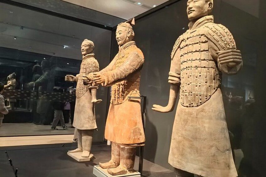 A museum display of ancient terracotta warrior statues. 5