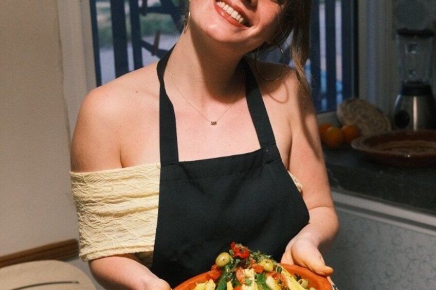 A person holding a plate of food in a kitchen. 3