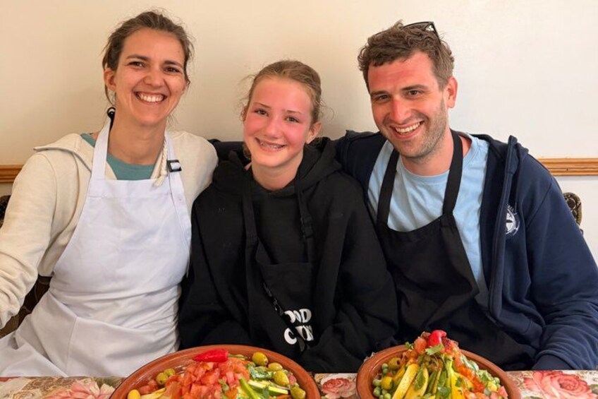 Three people sitting at a table with bowls of food. 2