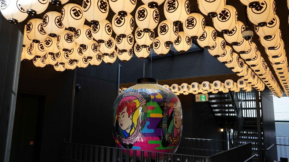 A colorful spherical object with a face, surrounded by traditional lanterns with Japanese characters. 3