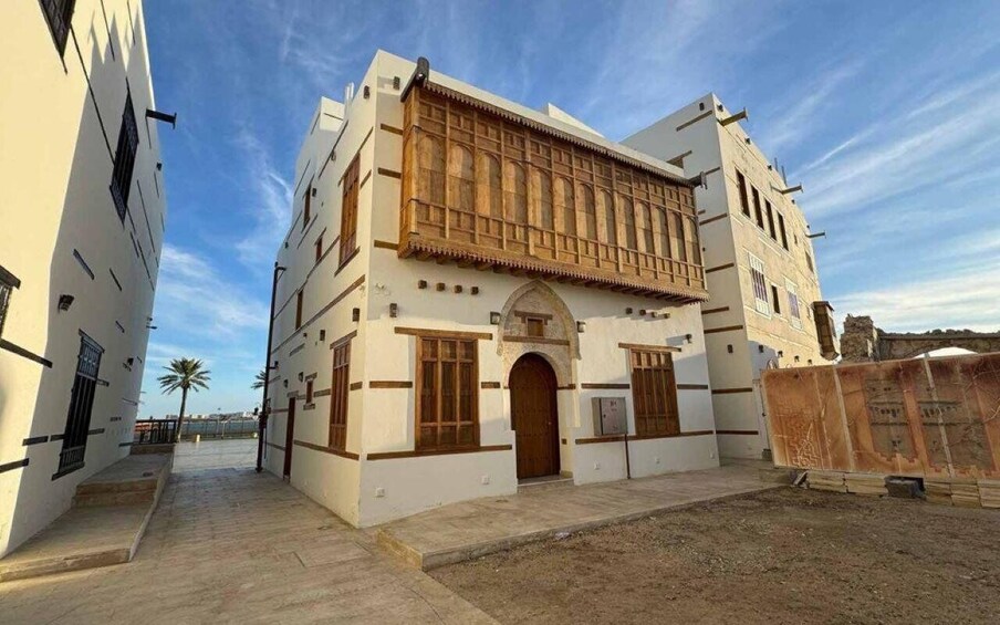 A traditional building with a wooden facade, arched doorways, and a tiled roof. 1