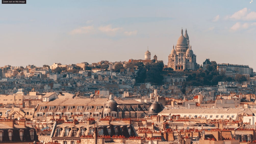 A cityscape with a prominent domed building in the background, surrounded by densely packed buildings. 2